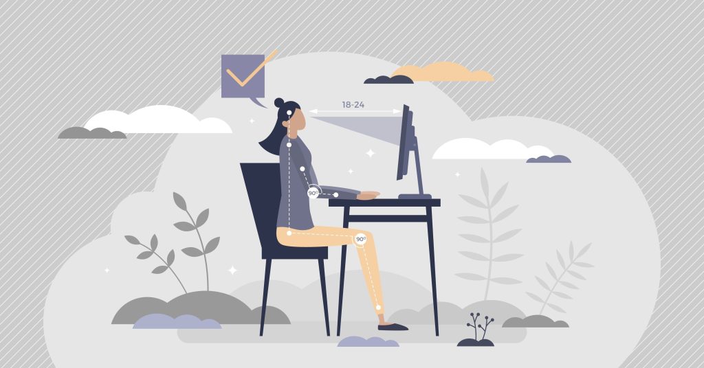 Woman seated at a desk demonstrating ideal posture

